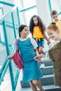 happy adorable classmates walking down stairs Royalty Free Stock Photo