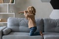 Happy adorable small boy playing alone at home.