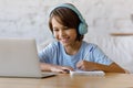 Happy teenage kid boy studying on online courses. Royalty Free Stock Photo