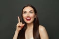 Happy adorable woman with long healthy straight hair pointing up. Skincare and facial treatment concept Royalty Free Stock Photo