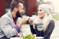 Happy adult couple dating in cafe