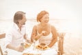 Happy adult couple eat and drink in shore cafe Royalty Free Stock Photo