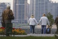 Happy adult couple holding hands and walking in park