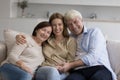 Happy adult daughter enjoying meeting with senior parents at home Royalty Free Stock Photo