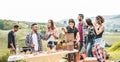 Happy adult friends eating at picnic lunch in italian vineyard outdoor - Young people having fun on gastronomic weekend tuscany Royalty Free Stock Photo