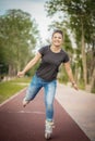 A girl rides roller skates in a city Park in summer