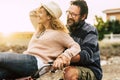 Happy adult people cheerful couple enjoy the outdoor leisure activity riding a bike together man carrying woman and laugh a lot in Royalty Free Stock Photo