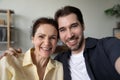 Happy adult son and mature mom hugging with love Royalty Free Stock Photo