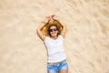 Happy adult woman lay donw on the sand beach enjoying summer sun and holiday vacation - one beautiful iddle age female people  in Royalty Free Stock Photo