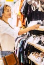 Happy adult woman portrait doing shopping in clothes store with shoes and shirts - shopping commecial center activity with trendy Royalty Free Stock Photo