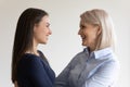 Happy affectionate loving senior mother and grownup daughter talking, hugging Royalty Free Stock Photo