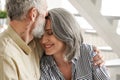 Happy affectionate mature husband embracing kissing wife enjoying tenderness. Royalty Free Stock Photo