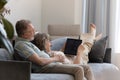 Happy middle aged couple using laptop at home. Royalty Free Stock Photo