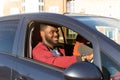 Happy African American in a blue car Royalty Free Stock Photo