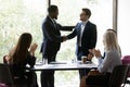 Happy African American business leader shaking hands with promoted employee Royalty Free Stock Photo