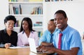 Happy african american businessman with team and computer Royalty Free Stock Photo