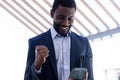 Happy african american businessman using tablet outside modern office Royalty Free Stock Photo