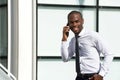 Happy african american businessman walking and talking with cellphone Royalty Free Stock Photo