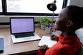 Happy african american businesswoman having video call writing notes using laptop with copy space Royalty Free Stock Photo