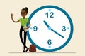 Happy african american businesswoman stand leaning to big clock Royalty Free Stock Photo