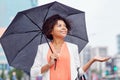 Happy african american businesswoman with umbrella