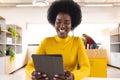 Happy african american casual businesswoman using tablet and having video call in creative office Royalty Free Stock Photo