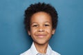 Happy African American Child Boy Smiling on Blue Background. Close up Kid Face Royalty Free Stock Photo