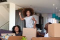 Happy African American child and parents unpacking boxes in new house Royalty Free Stock Photo