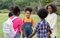 Happy African American childrens standing and holding hands together in circle in the park Royalty Free Stock Photo