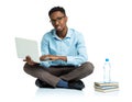 Happy african american college student with laptop, books and bo Royalty Free Stock Photo