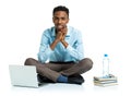 Happy african american college student with laptop, books sitting on white background Royalty Free Stock Photo