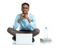 Happy african american college student sitting with laptop on white Royalty Free Stock Photo