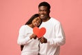 Happy african american couple celebrating love, pink background Royalty Free Stock Photo