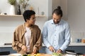 Happy African American couple cooking in kitchen. Royalty Free Stock Photo