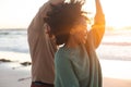 Happy african american couple dancing and smiling on sunny beach Royalty Free Stock Photo