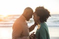 Happy african american couple dancing and smiling on sunny beach Royalty Free Stock Photo