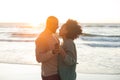 Happy african american couple dancing and smiling on sunny beach Royalty Free Stock Photo