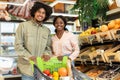 Happy African American Couple Doing Grocery Shopping Posing In Store Royalty Free Stock Photo