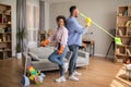 Happy African American Couple Doing Housework Cleaning House Singing Indoors Royalty Free Stock Photo