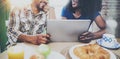 Happy african american couple are having breakfast together in the morning at the wooden table.Smiling black man and his Royalty Free Stock Photo