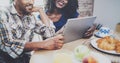 Happy african american couple are having breakfast together in the morning at the wooden table.Smiling black man and his Royalty Free Stock Photo