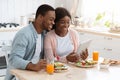 Happy African American Couple Having Breakfast And Using Digital Tablet In Kitchen Royalty Free Stock Photo