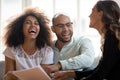 Happy African American couple laughing at meeting with realtor