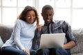 Happy African American couple in love using laptop together