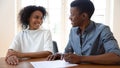 Happy African American couple making deal, signing contract in office Royalty Free Stock Photo