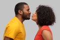 Happy african american couple reaching for kiss