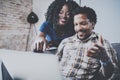 Happy african american couple relaxing together on the sofa.Young black man and girl using modern laptop for video Royalty Free Stock Photo