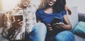 Happy african american couple relaxing together on the sofa.Young black man and his girlfriend using smartphones while Royalty Free Stock Photo