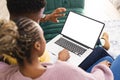 Happy african american couple sitting on sofa and using laptop with copy space in living room Royalty Free Stock Photo