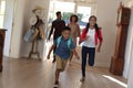 Happy african american couple with son and daughter back from school embracing and smiling at home Royalty Free Stock Photo